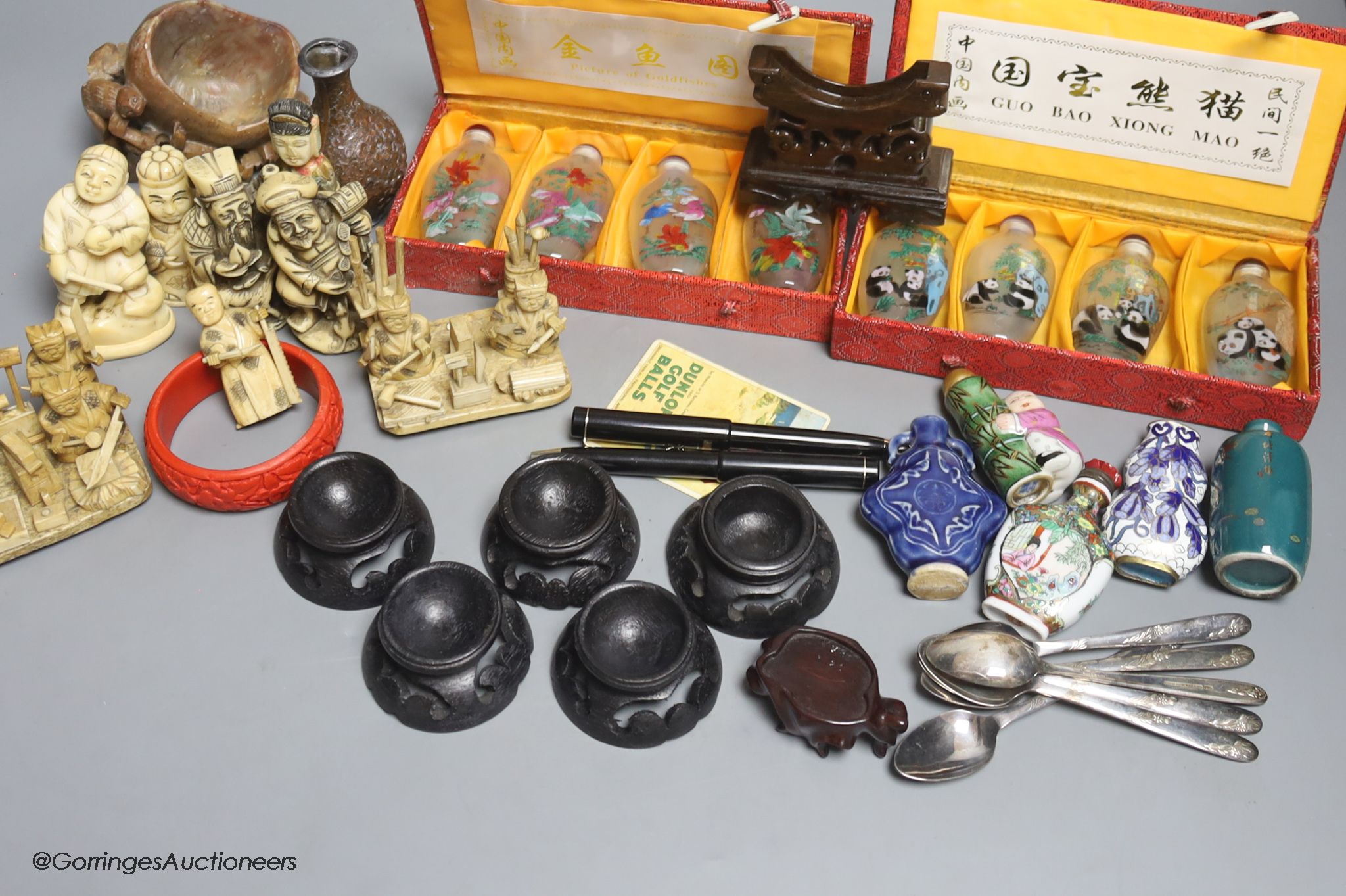 A collection of miscellaneous snuff bottles, figurative carvings, stands etc